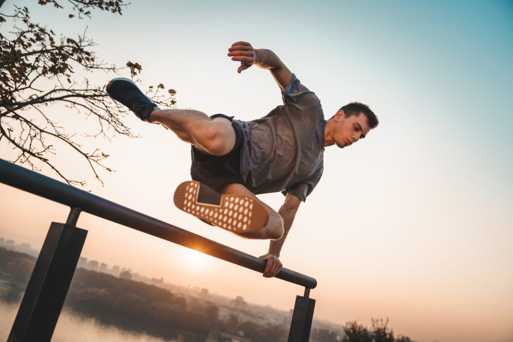 Athlete jumping over a wall. Free running parkour - Stock photo
