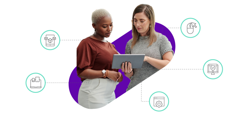 Two women looking at a laptop in conversation