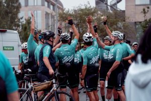 Riders at the Colt Charity Bike Ride high fiving